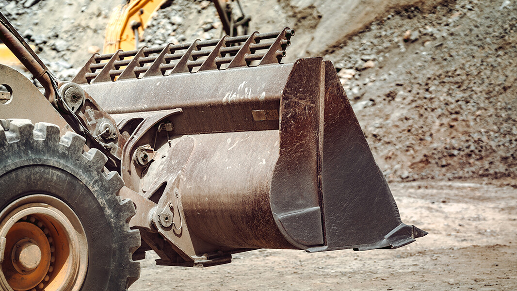 Heavy duty wheel loader working on mining site.