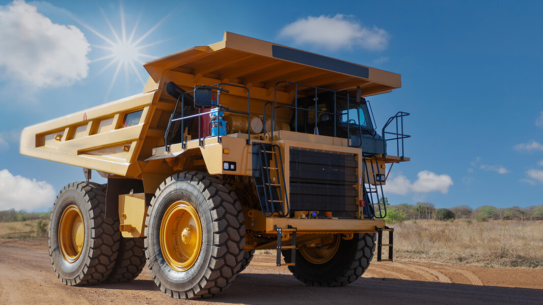 diamond mine truck driving on a dirt road in the scorching sun